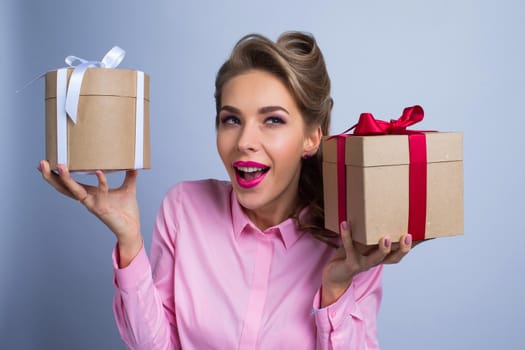 Young woman puts her ear to the presents with bows