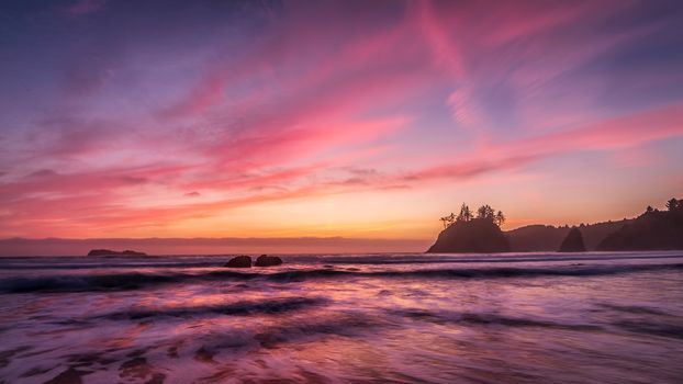 This is a color landscape photo of a vivid sunset over the Pacific Ocean.