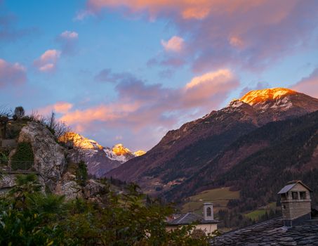 Amazing panorama of the snow-covered Orobie mountains of the Seriana Valley and the Sedornia Valley at sunset.