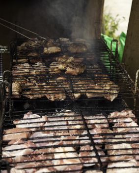 Meat on the grill, roasting meat on an ember with fire