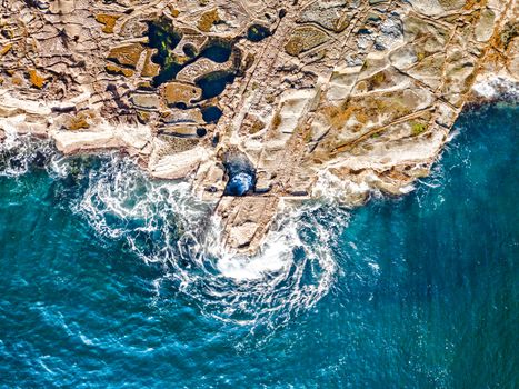 Textured rock platform, deep rock pools and swirling ocean swells