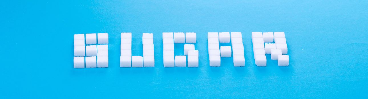 White sugar cubes background - Concept of unhealthy eating