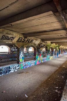Tunnel in urban area with trash and graffiti