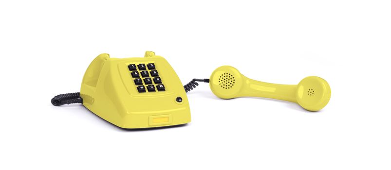 Vintage yellow telephone with a white background