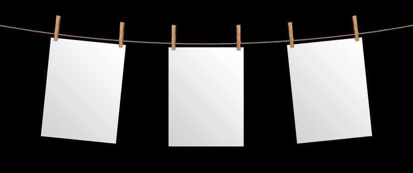 Empty paper sheet hanging on rope, isolated on black background, mock up for your project presentation, poster template