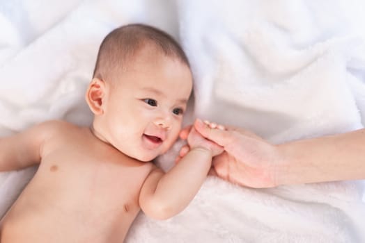 portrait asia baby on white bed