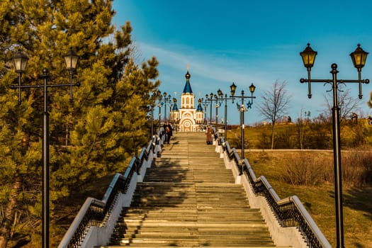 stairs from the embankment of the Amur river, ending at Komsomolskaya square. On the horizon Grado-Khabarovsk Cathedral of the assumption of the Mother of God
