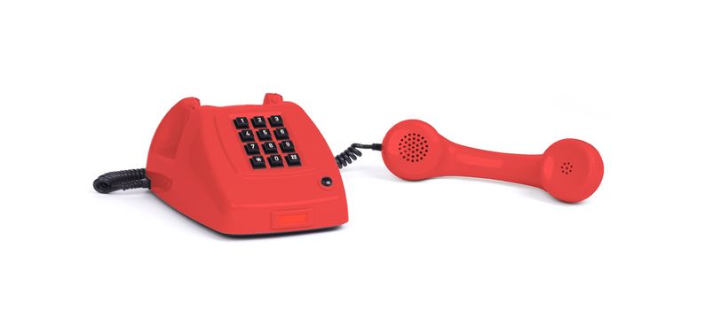 Vintage red telephone with a white background