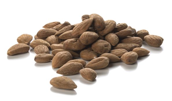 Close up photography of raw almonds heap over white background. Packshot style 