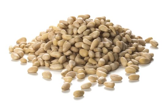 Close up photography of pine nuts heap over white background. Packshot style 