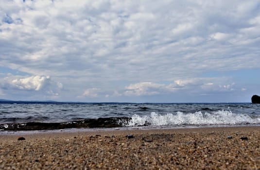 view of the lake with cumulonimbus clouds above it in windy weather, low point shooting