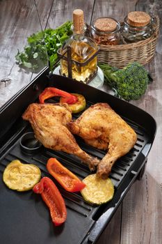 Roasted chicken and vegetables on a wooden table