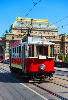 Red vintage tram in the old streets of Prague