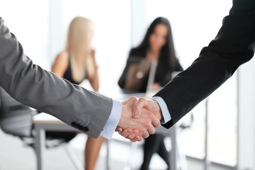 Close-up of handshake of businessmen on meeting in office