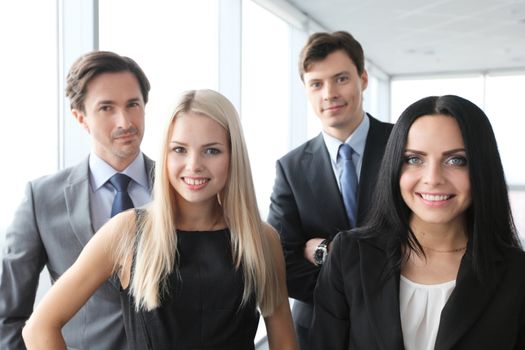 Happy business team of coworkers in office