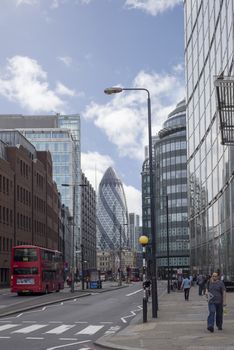 london red bus and city buildings with street