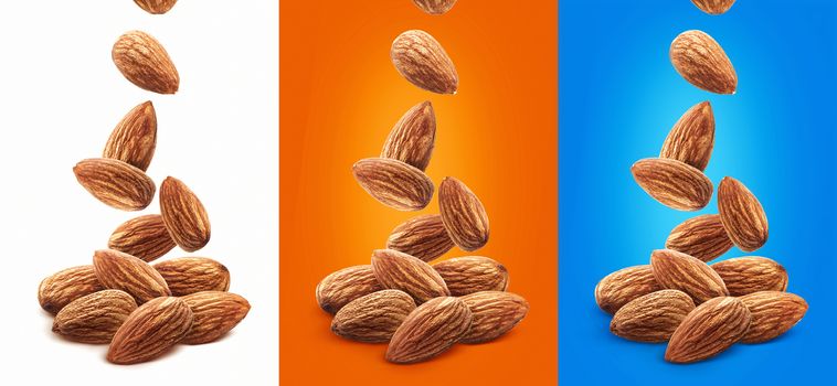 Falling almond nuts isolated on white background with clipping path, closeup, nut packaging concept