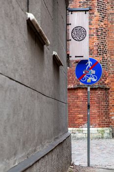 St. Peter's church fragment. Road sign End Of  Path For Pedestrians And Cyclists in the Old Riga, Latvia. Street in center of Old Riga.