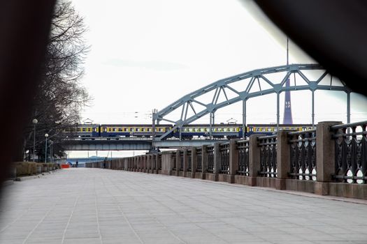 View of the Railway bridge from the 11th November Embankment, Riga, Latvia. Behind the railway bridge can see the television tower. Bridge crossing train. 