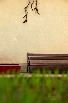 Fragment of yellow wall with bench in Old Riga, Latvia. Bench at the wall in Riga city.