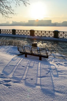 View of Riga from the 11th November Embankment side. Riga view in winter. Frozen river Daugava at the 11th November Embankment.