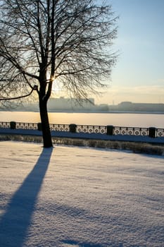 View of Riga from the 11th November Embankment side. Riga view in winter. Frozen river Daugava at the 11th November Embankment.