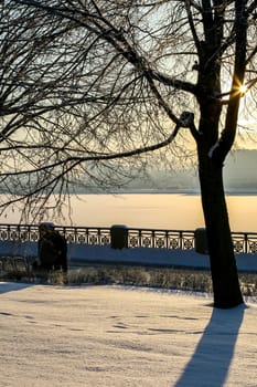 View of Riga from the 11th November Embankment side. Riga view in winter. Frozen river Daugava at the 11th November Embankment.