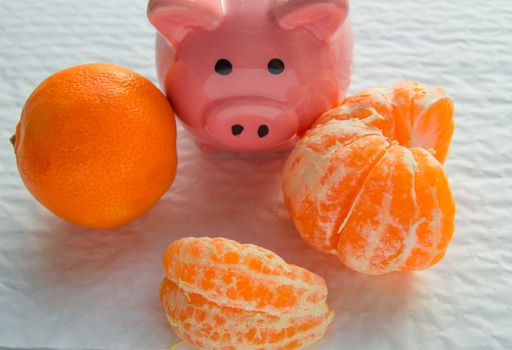 Chinese New year with copy space, piggy Bank and tangerines on white background.