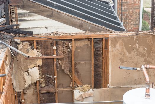 Close-up the roof of damaged apartment after burned by fire in Texas, America. Smoke and dust in burn scene of arson investigation course. Insurance theme of fire devastated