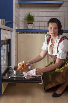 bavarian woman in a dirndl cooking