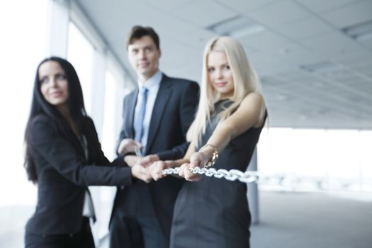 Businessmen pulling chain, teamwork togetherness concept