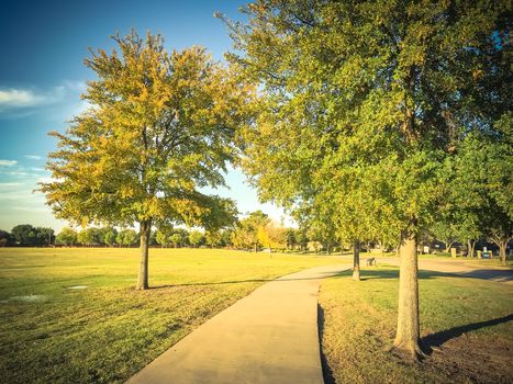 Vintage tone image of empty curved pathway in city park suburbs of Dallas, Texas, USA