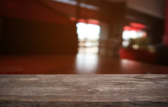 Empty dark wooden table in front of abstract blurred bokeh background of restaurant . can be used for display or montage your products.Mock up for space