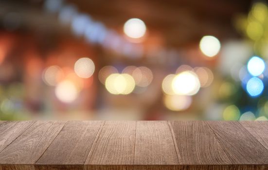 Empty dark wooden table in front of abstract blurred bokeh background of restaurant . can be used for display or montage your products.Mock up for space