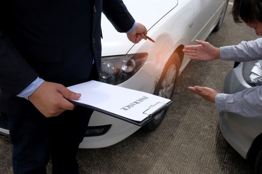 Loss Adjuster Insurance Agent Inspecting Damaged Car