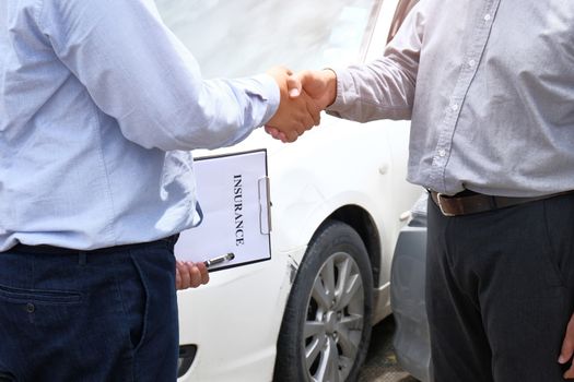 Loss Adjuster Insurance Agent Inspecting Damaged Car