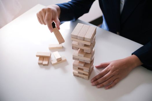 Planning risk and strategy in businessman gambling placing wooden block.Business concept for growth success process.