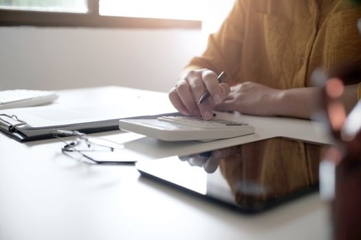 Business accounting women work with calculator and Laptop. Financial technology concept.