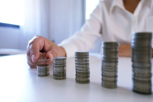 Female hand stack coins  growing business. Saving money