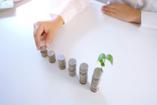 Female hand stack coins  growing business. Saving money