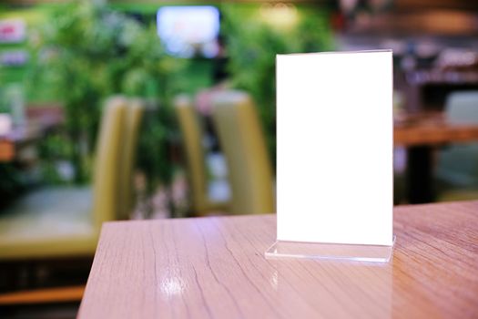 Menu frame standing on wood table in Bar restaurant cafe. space for text marketing promotion