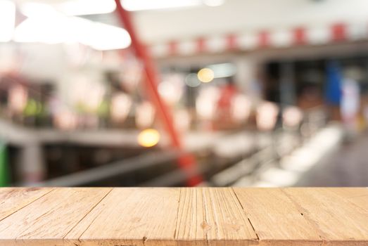 Empty dark wooden table in front of abstract blurred background of cafe and coffee shop interior. can be used for display or montage your products