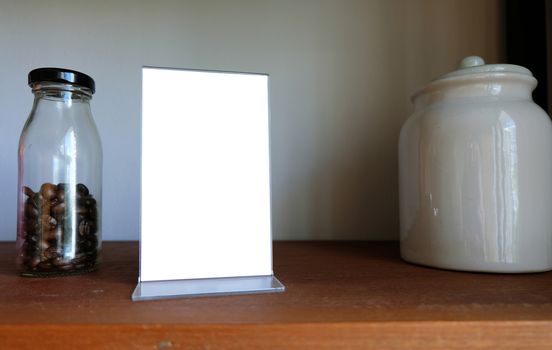 Mock up Menu frame standing on wood table in Bar restaurant cafe. space for text