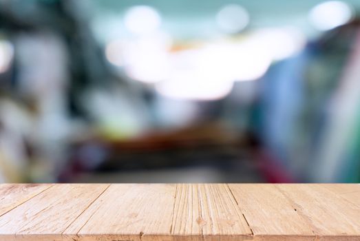 Empty wooden table in front of abstract blurred background of coffee shop . can be used for display Mock up  of product.