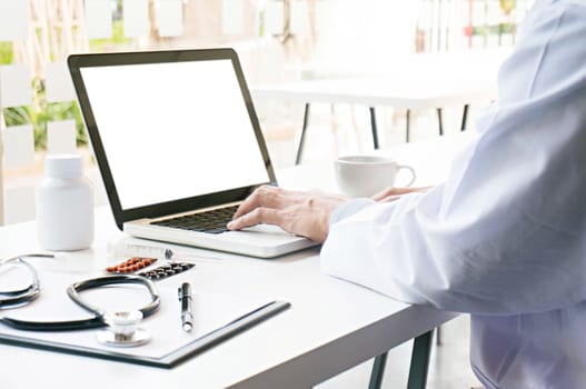 View of Details of doctor hands typing on keyboard with blank screen