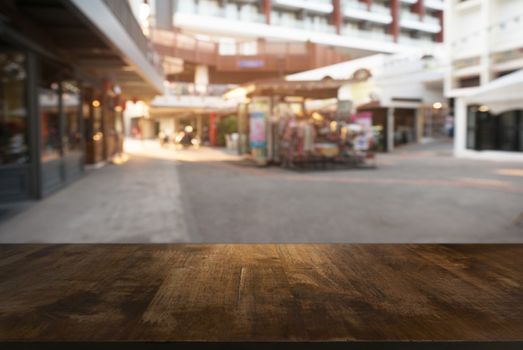 Empty wooden table in front of abstract blurred background of coffee shop . can be used for display Mock up  of product.