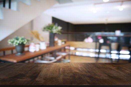 Empty wooden table in front of abstract blurred background of coffee shop . can be used for display or montage your products.Mock up for display of product