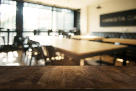 Empty wooden table in front of abstract blurred background of coffee shop . can be used for display or montage your products.Mock up for display of product