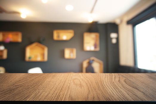 Empty wooden table in front of abstract blurred background of coffee shop . can be used for display or montage your products.Mock up for display of product