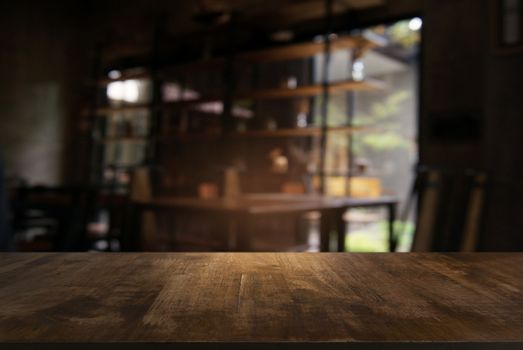 Empty wooden table in front of abstract blurred background of coffee shop . can be used for display or montage your products.Mock up for display of product